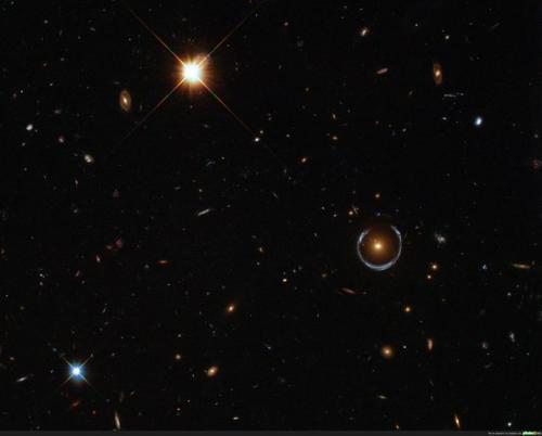 Видите этот голубой объект, который смог обернуть собой целую галактику?